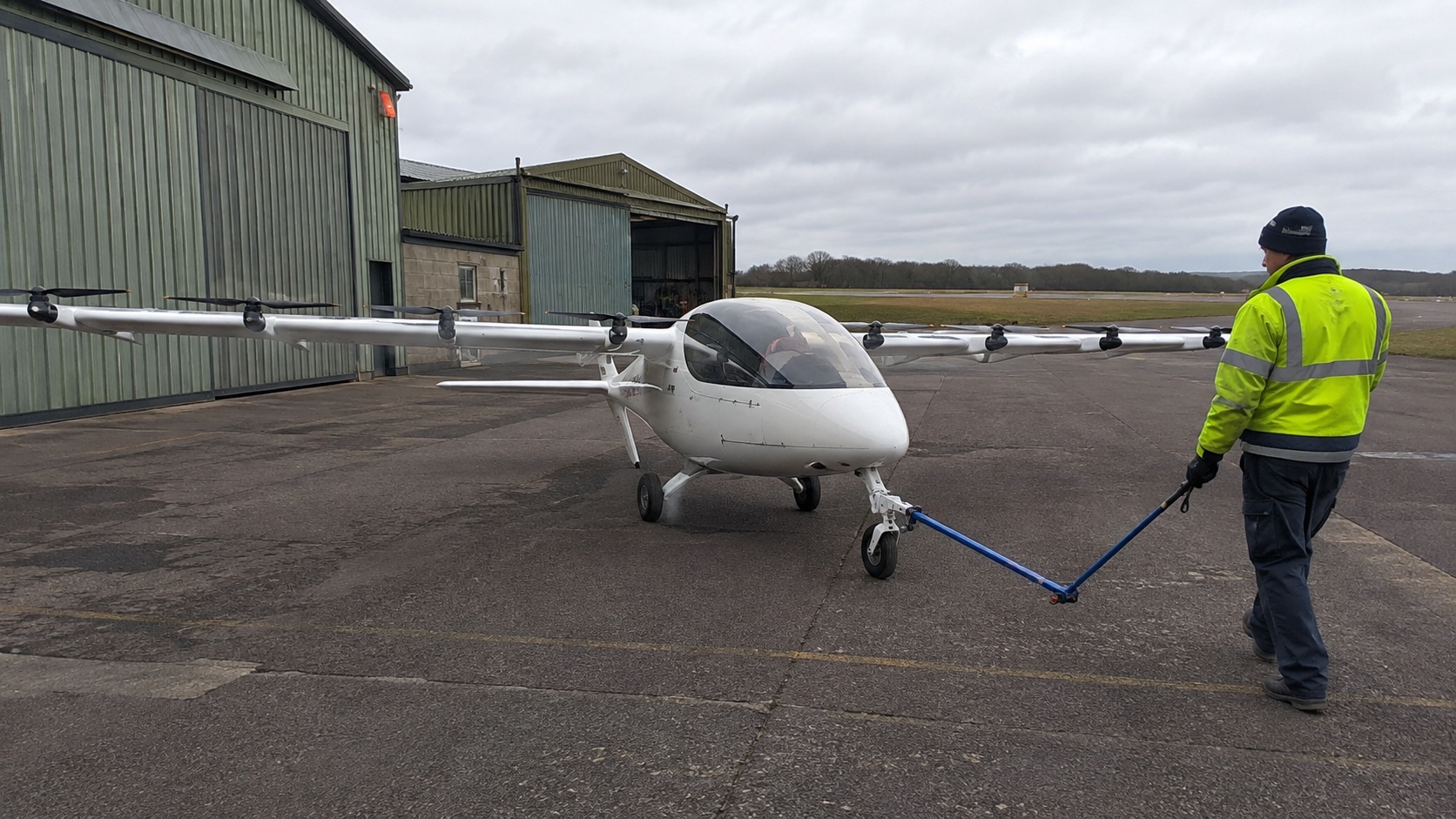Electric aircraft preparing for a test flight at a small airfield